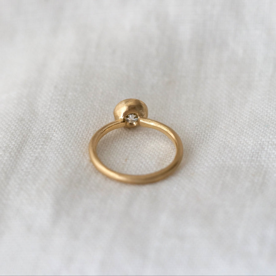 Gold ring on a white fabric background