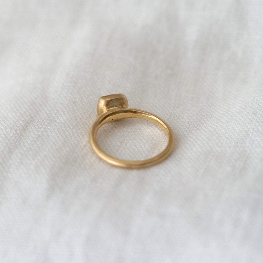 Gold ring on a white fabric background