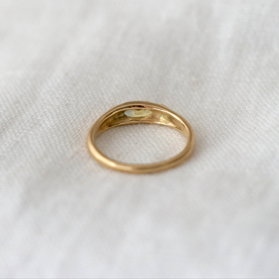 Gold ring on a white fabric background