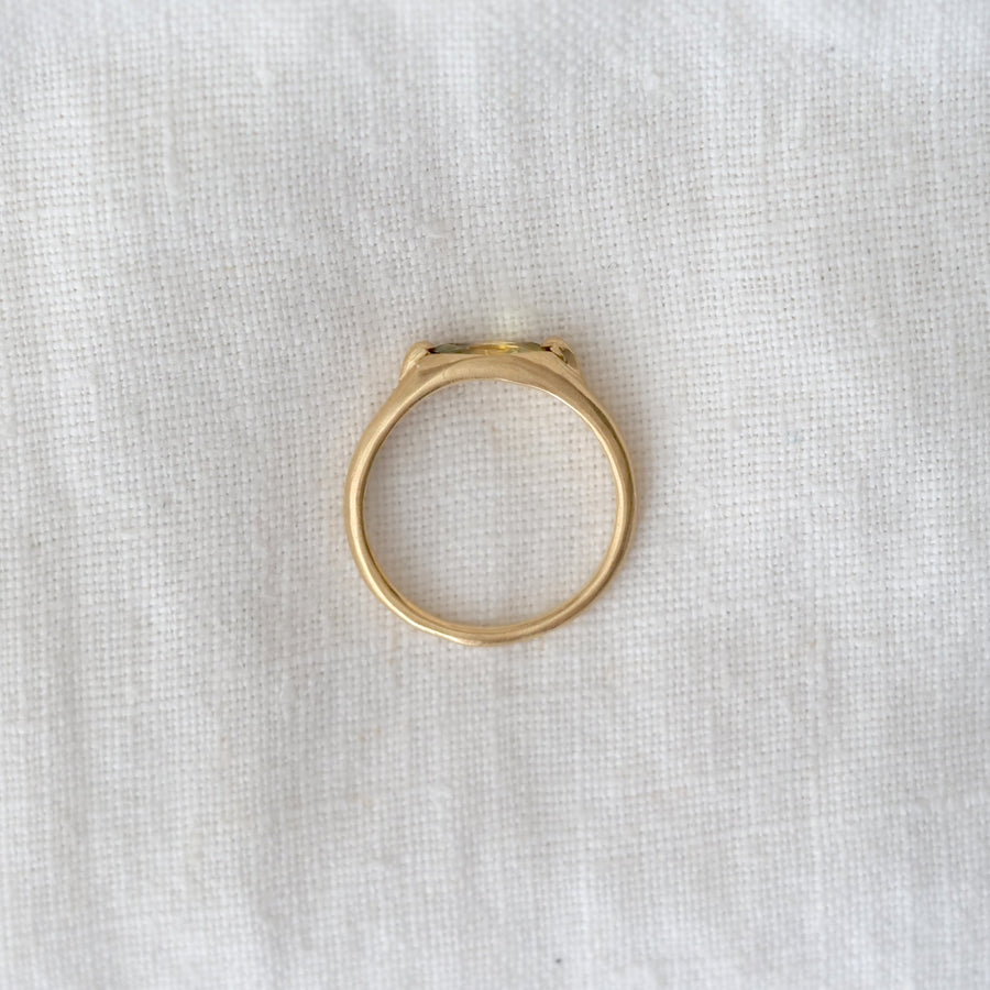Gold ring on a white fabric background