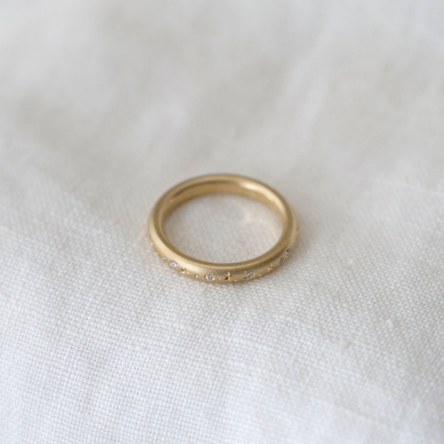 Gold ring on a white fabric background