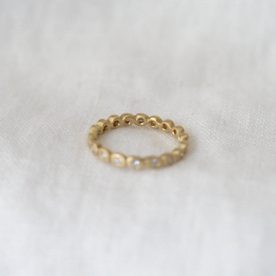 Gold ring on a white fabric background