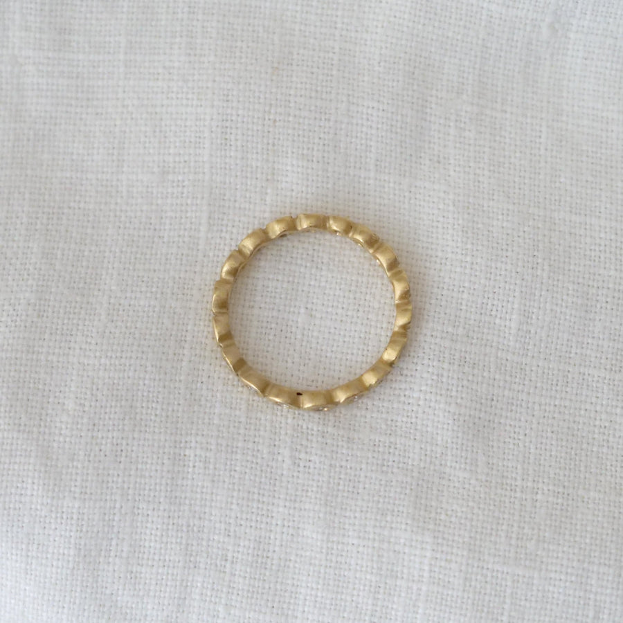 Gold ring on a white fabric background