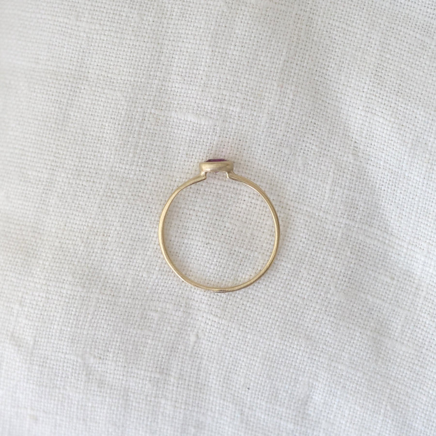 Gold ring on a textured white fabric background
