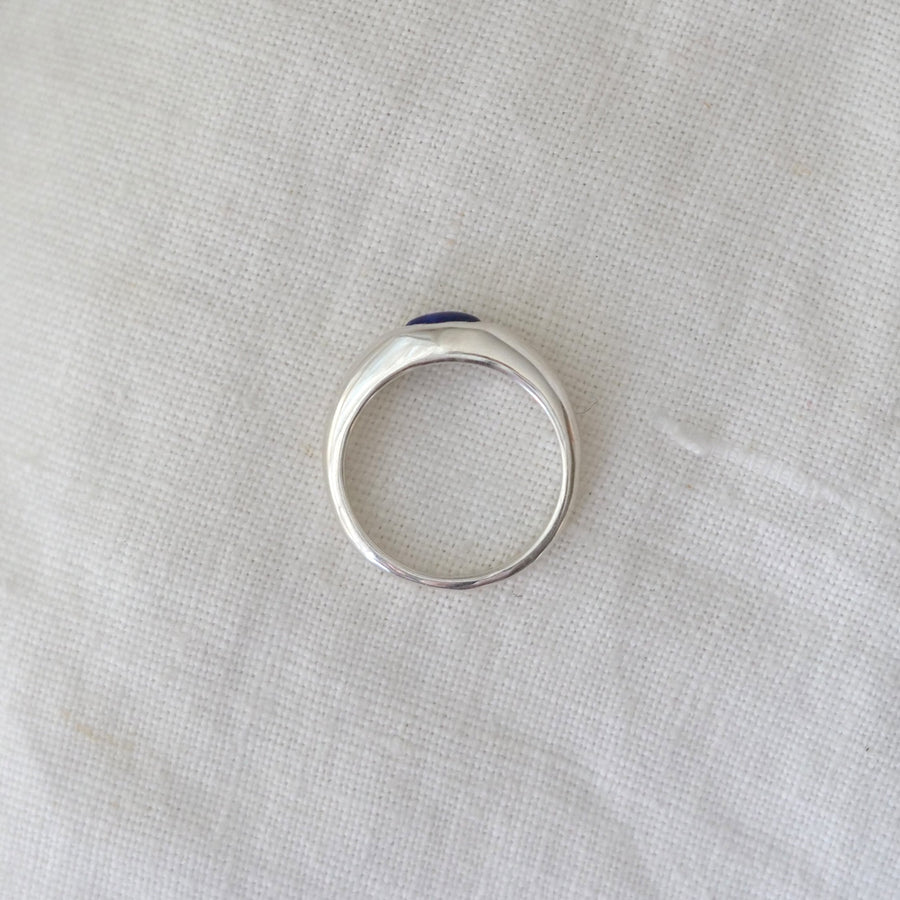 Silver ring on a light fabric background