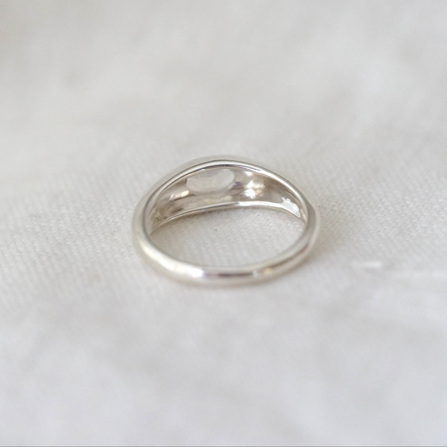 Silver ring on a white fabric background