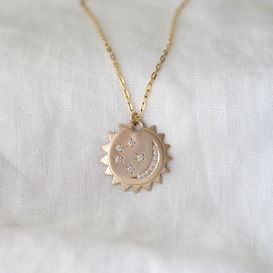14k yellow gold pendant with a diamond crescent moon and diamond stars, on a 14k gold chain.