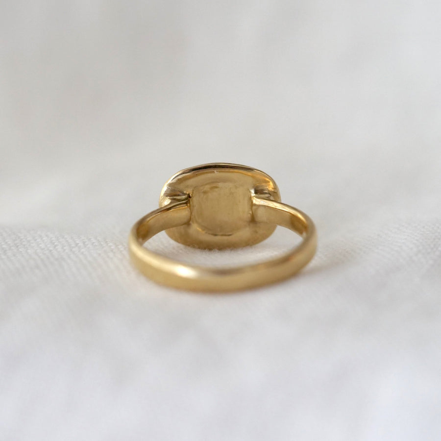Gold ring on a white fabric background