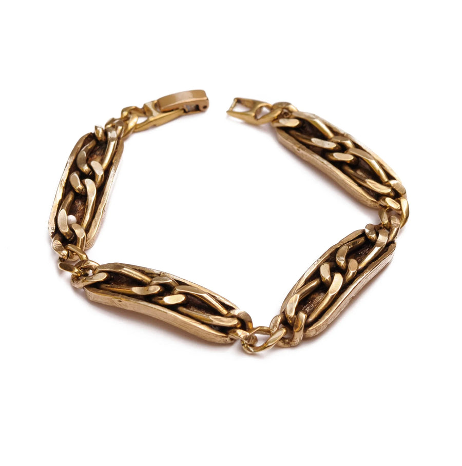 Faceted curb chain, cast on a hand carved carved channel. Brass with a fold-over style clasp. 7 1/4