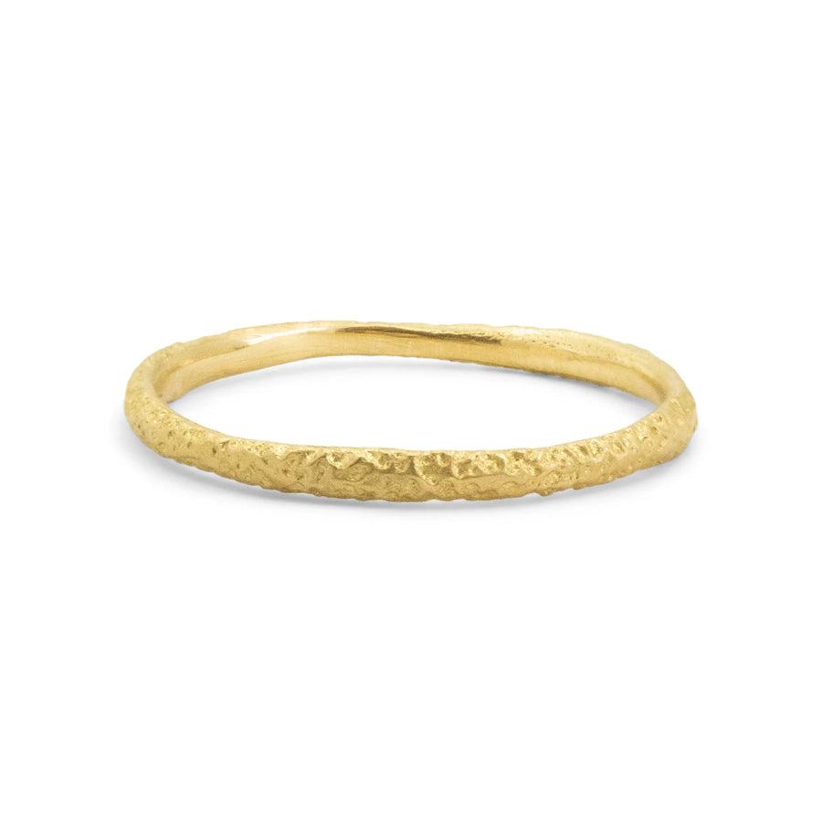 rounded 18k yellow gold band with hand engraved sand texture