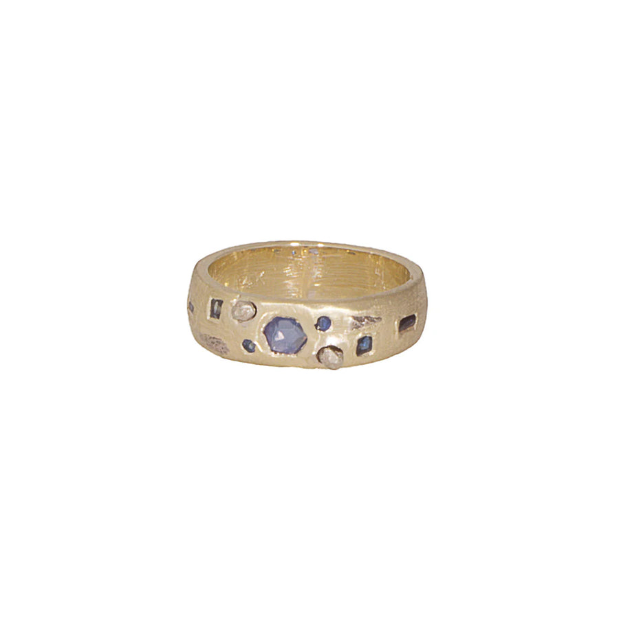 Gold ring with embedded blue sapphires stones and white gold, on a white background