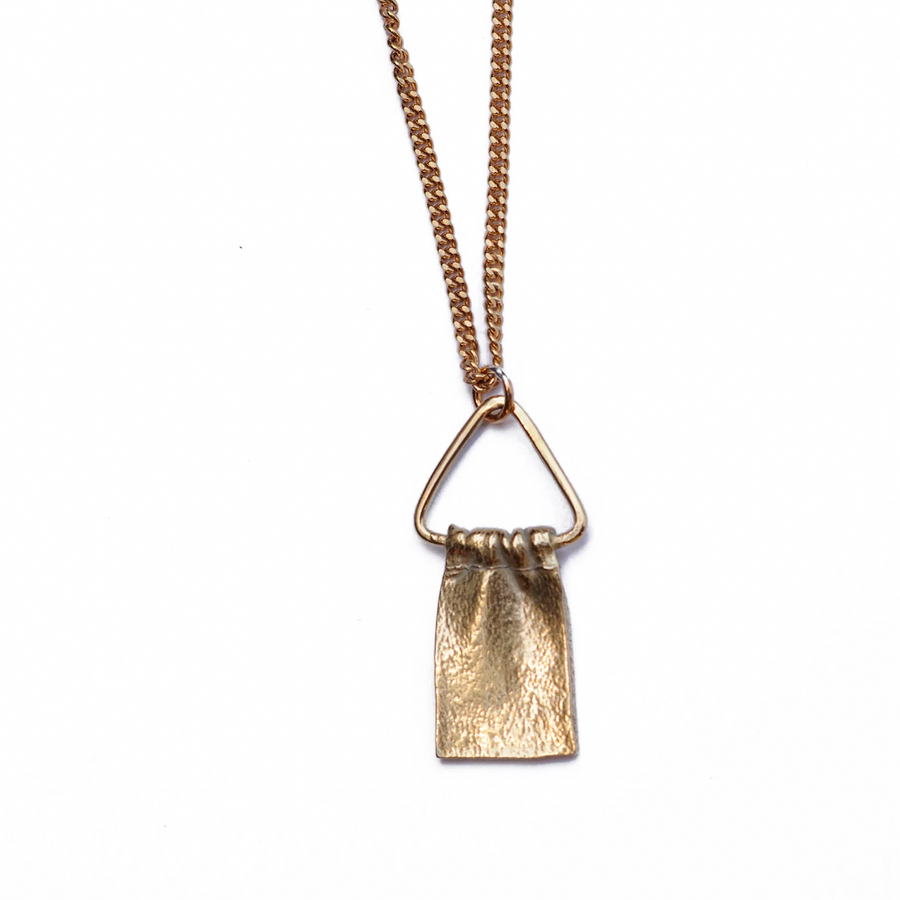 Brass pedant cast to look like fabric, hanging on triangle on brass curb chain Marisa Mason Jewelry