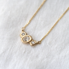 3 of 3: Organically sculpted 3 stone necklace, with one larger oval cut diamond and 2 small round diamonds on either side, bezel set in 14k yellow gold.  Marisa Mason Jewelry