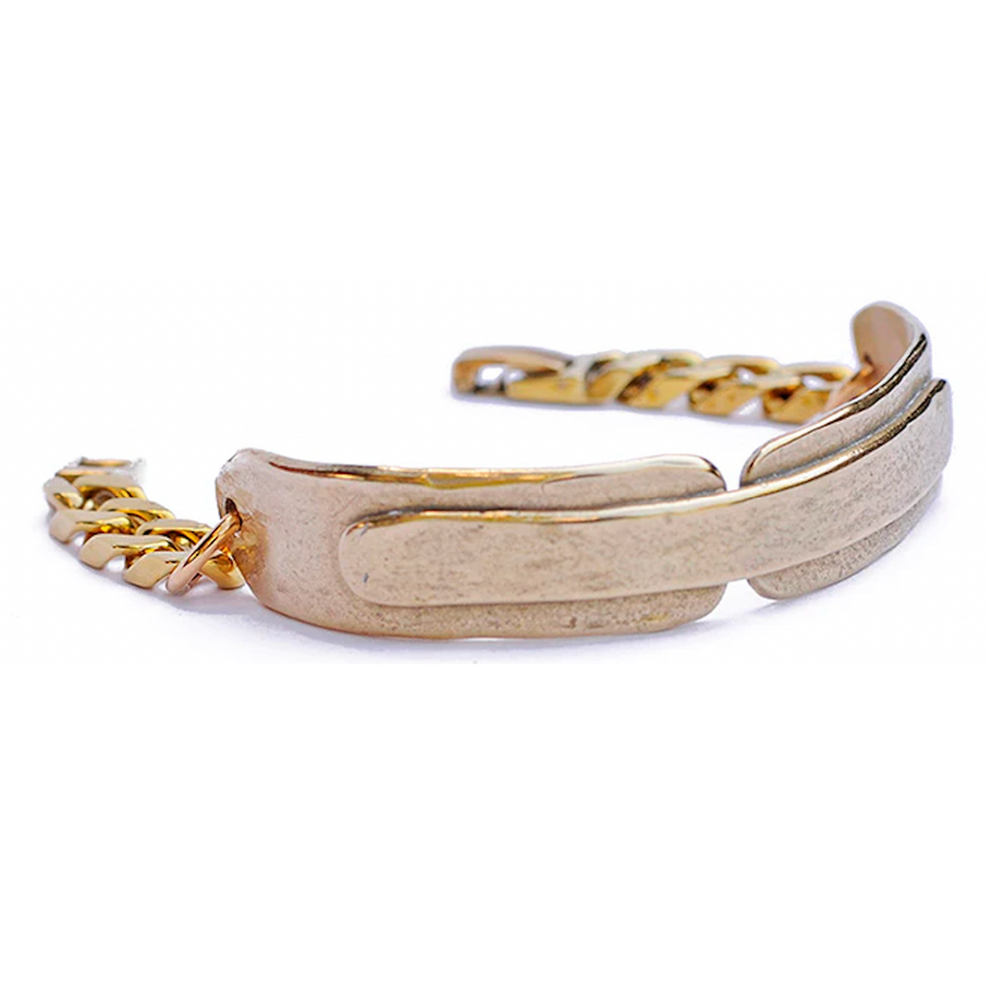 Cast in brass with a leather-like texture and a chunky brass curb chain.    Bracelet is 6 1/2