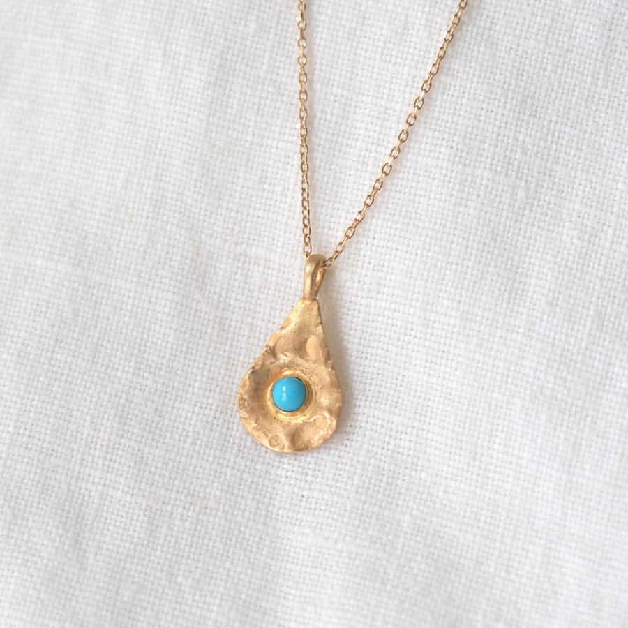 With one turquoise cabochon set in an 18K tear drop shape, the organic texture of the surface makes this pendant even more intriguing to the eye. 