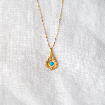 With one turquoise cabochon set in an 18K tear drop shape, the organic texture of the surface makes this pendant even more intriguing to the eye. 