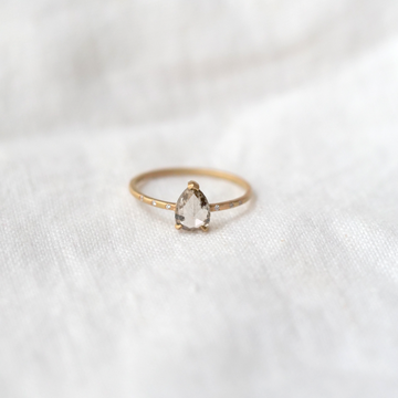 The daintiest 18k band set with a Salt and Pepper rose-cut solitaire, flanked by the most delicate brilliant cut side diamonds.