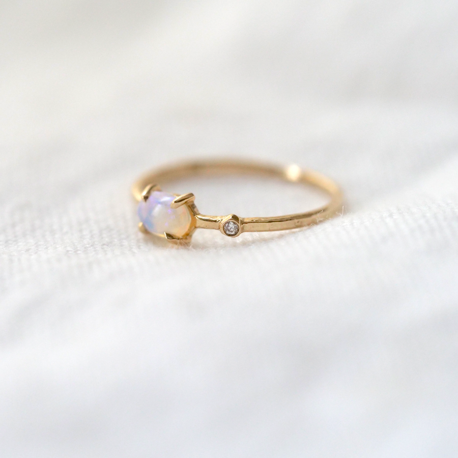 Opal and diamond set in 14k gold band.