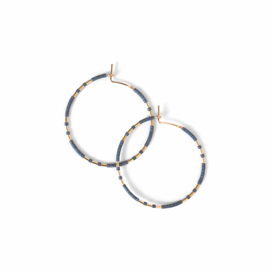 The Chaldene hoop earrings have a fixed pattern of gold beads evenly patterned in threes among matte glass beads. 