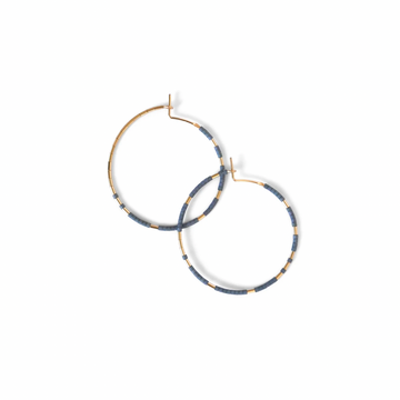 The Abacus Row Pan Hoops showcase an asymmetrical design of unexpected patterning of gold among matte glass beads.