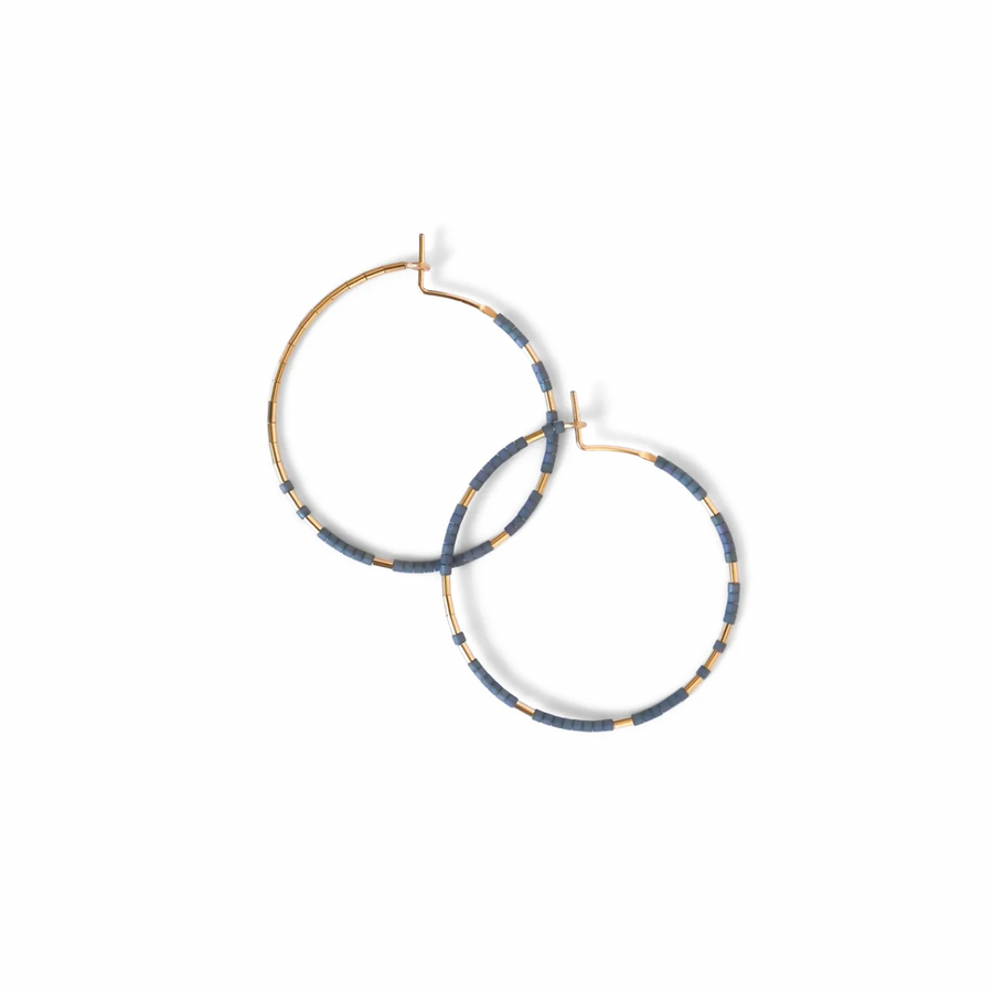 The Abacus Row Pan Hoops showcase an asymmetrical design of unexpected patterning of gold among matte glass beads.