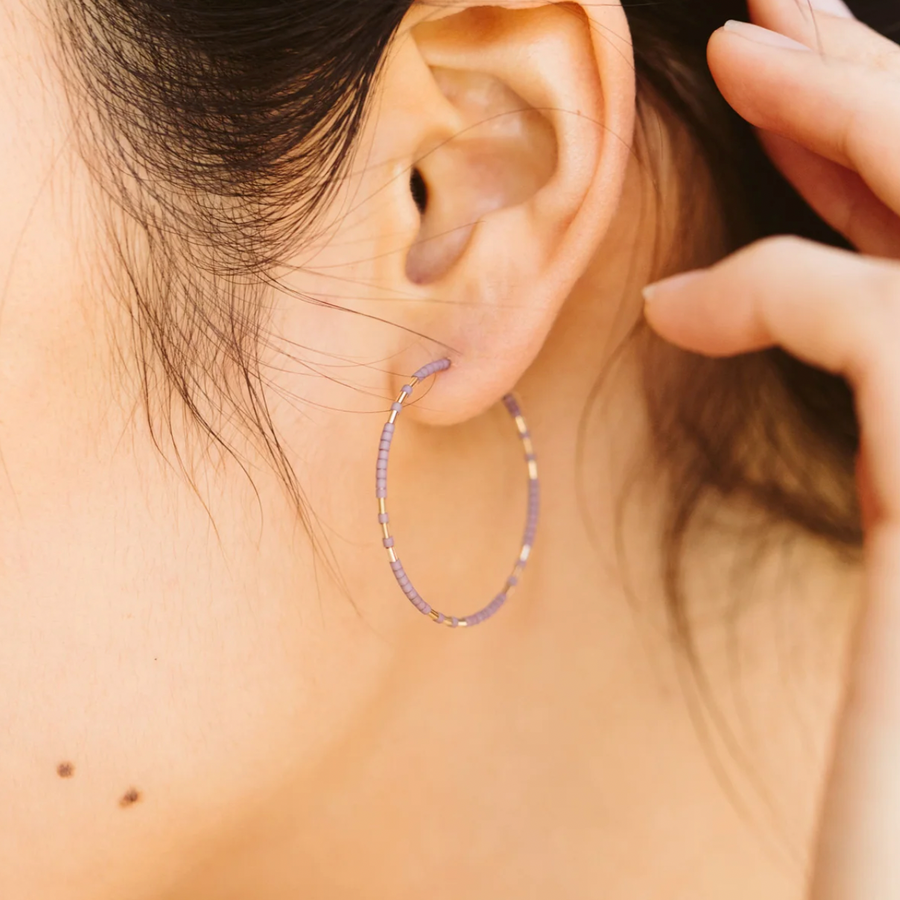 The Chaldene hoop earrings have a fixed pattern of gold beads evenly patterned in threes among matte glass beads.