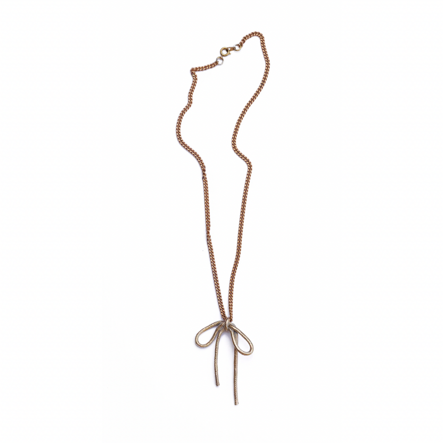 The sweetest accessory- this cast brass bow measures 2