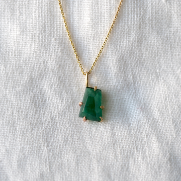 A dark green Brazilian Emerald hand-cut by Variance Jewelers, set in 14k yellow, rose and white gold. Chain is 20