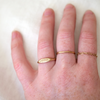 6 of 6: A oval face signet ring with a sweet little olive branch hand engraved on the front on a models hand