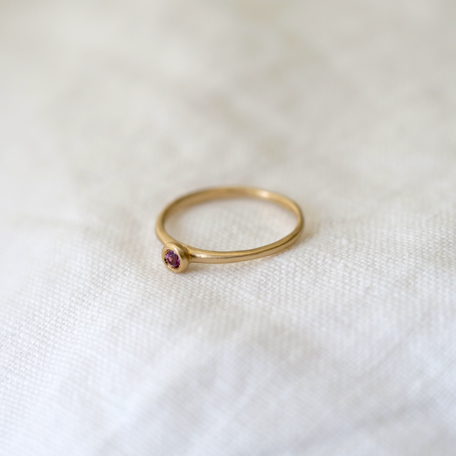 A lightweight gold band with a gorgeous 2.5mm rose cut pink garnet Marisa Mason Jewelry