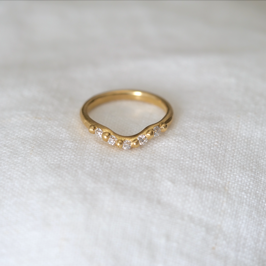 Small Contour Ring nests perfectly with our solitaires. 5 white diamonds set in 18k yellow gold, hand carved and hand cast