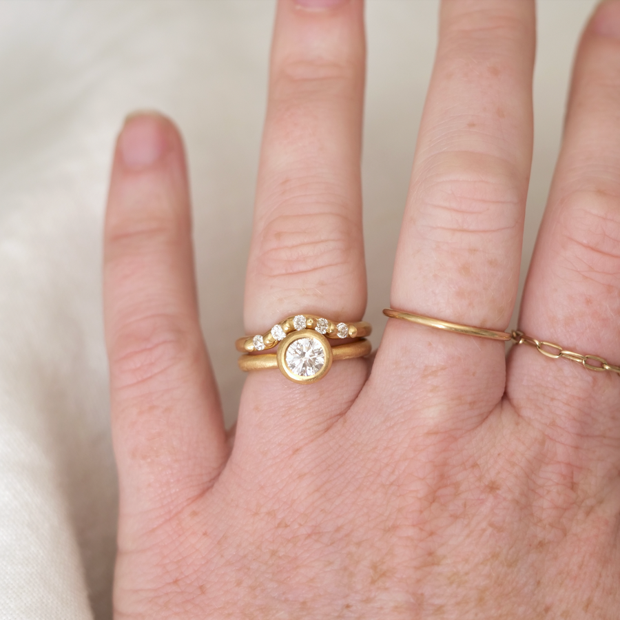 Small Contour Ring nests perfectly with our solitaires. 5 white diamonds set in 18k yellow gold, hand carved and hand cast on model 