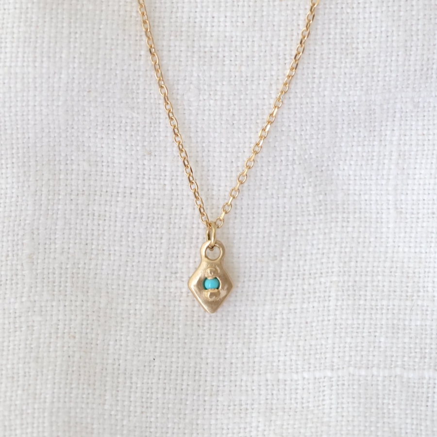 Delicate 14k gold diamond shaped pendent, bead-set with a turquoise point