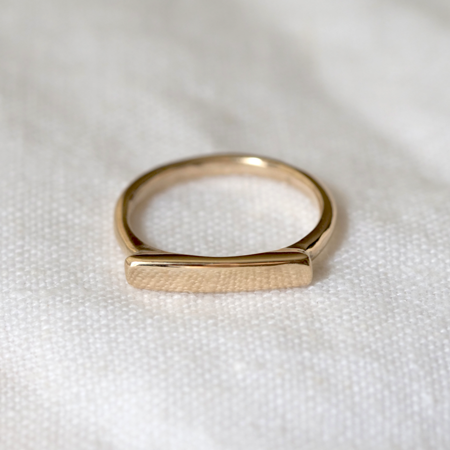 14k ring has a smooth rectangular face, perfectly engravable.