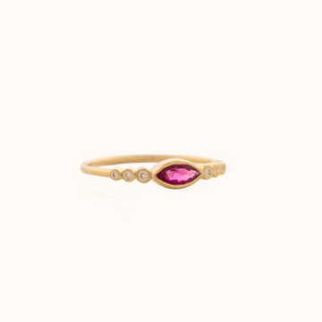 Thing gold band with marquise cut ruby, and three round white diamonds on either side.