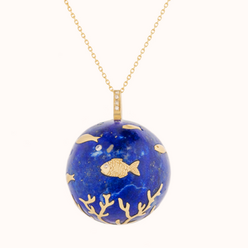 Solid lapis sphere inlayed with 14k gold fish and coral motifs. White diamonds are then inlayed on the top of the sphere to indicate bubbles, and diamonds set on the gold jump ring, attaching it to a 24 inch 14k gold chain