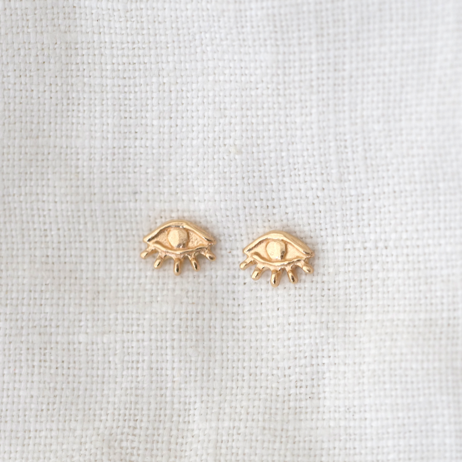 14k eye shaped stud earrings with Little bitty lashes rim the lower half