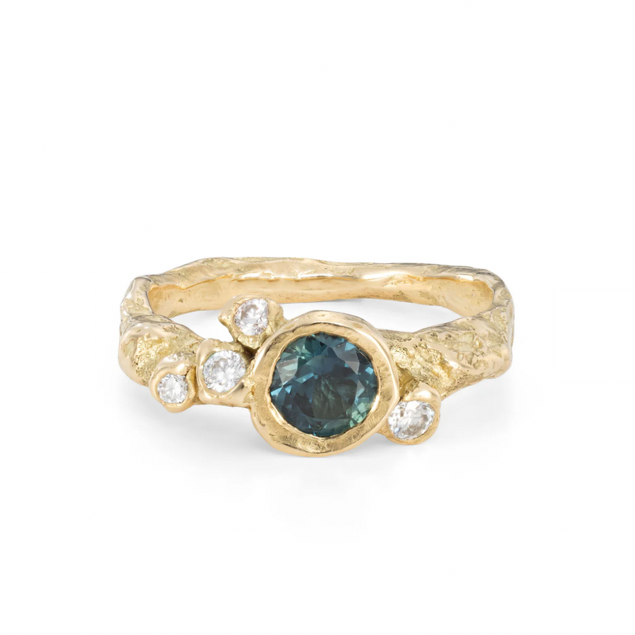 One Large round green sapphire bezel set in the center of four randomly around it, on thick gold band