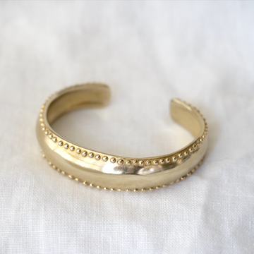 Tapered cuff with small granulated dots long the edge, creating a thick cuff 