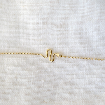 14k gold snake with diamond eyes, set in the center of a 14k gold cable chain 