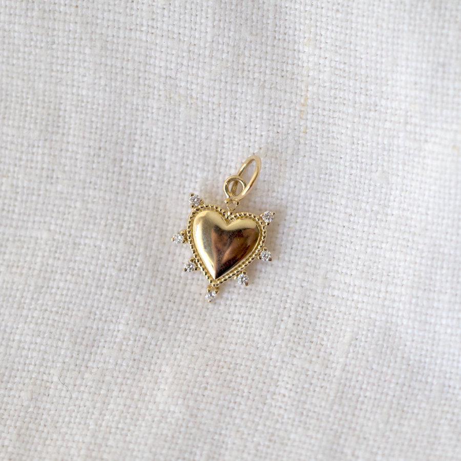 solid 14k heart with white diamond accents studding along the outside