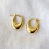 14k puffy hoops are formed into elegant ovals, measuring 22mm tall and 16mm across