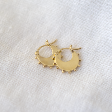 petite disc hoops are a great size for daily wear, with interesting granulated details along the bottom of the hoop. Made of solid 14k yellow gold