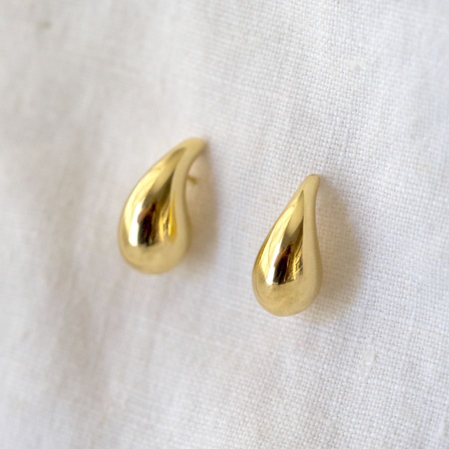 Hollow gold droplet studs, creating a large but light statement earring 