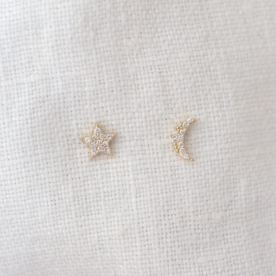 14k studs feature a small moon and a star (respectively) studded with pave white diamonds