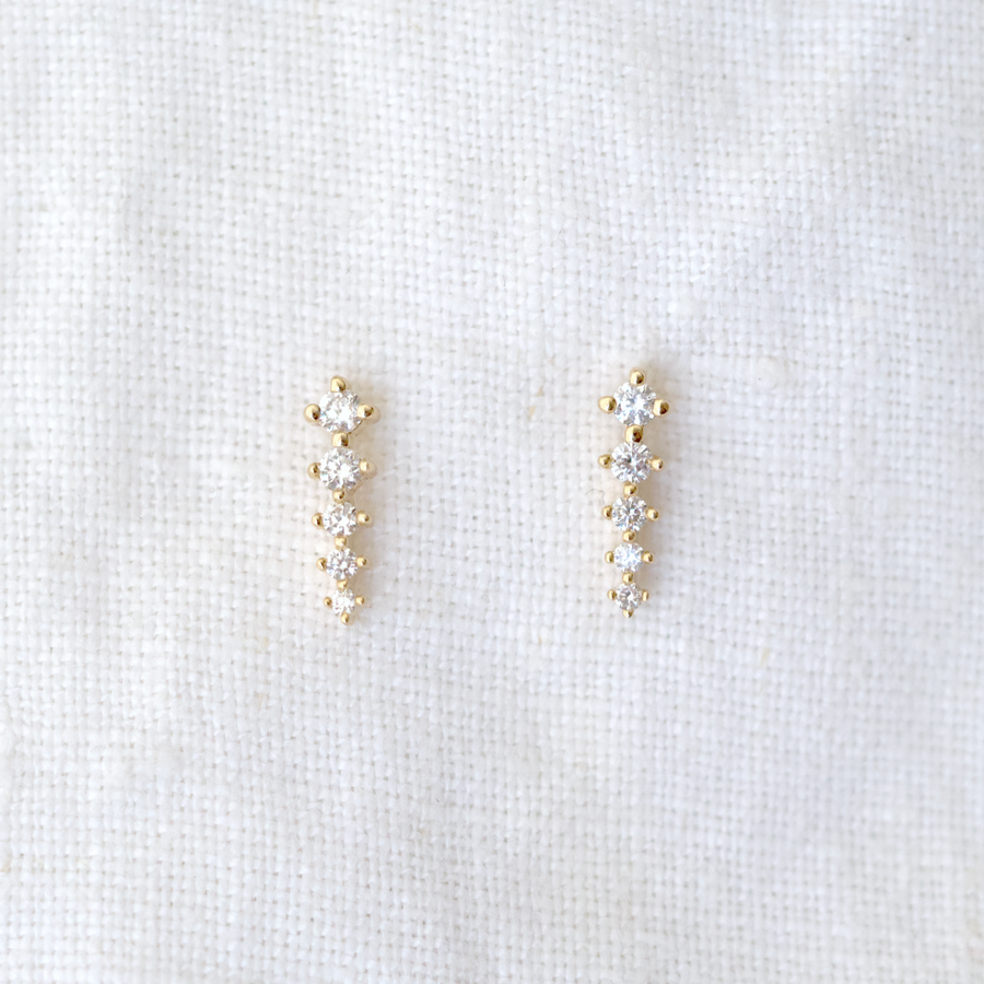 These prong-set earrings feature 5 bright white diamonds that graduate larger to smaller