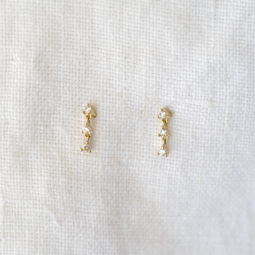  These small dangly earrings feature 3 prong-set diamonds that dangle and dance with every step