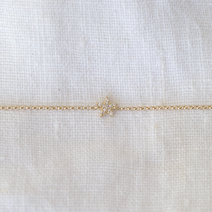 A little star crafted with 14k gold and encrusted with sparkling pave diamonds