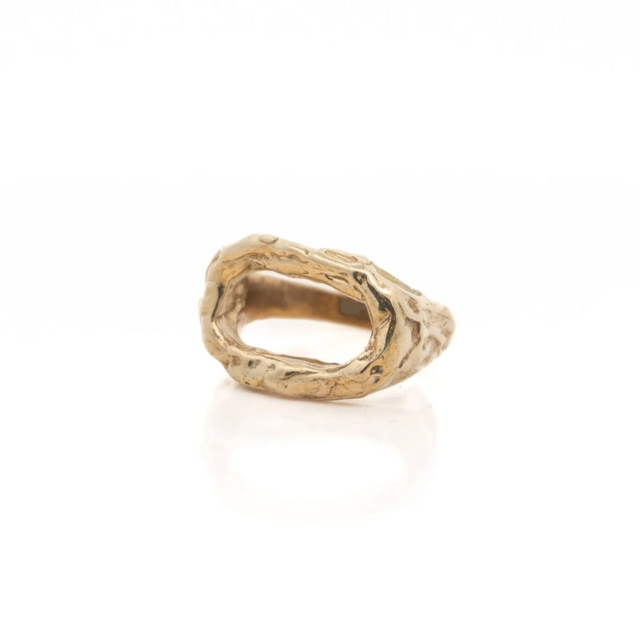 open brass ring with circle formation on white background