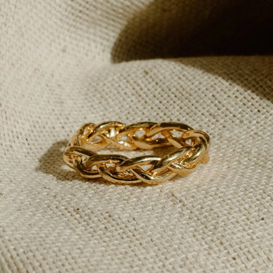 Casted brass carved ring of braided metal 